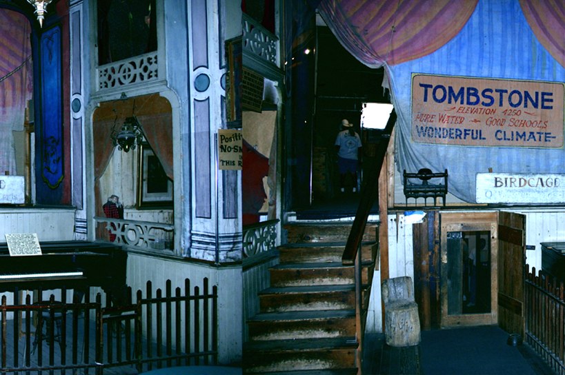 The entrance and front interior threshold of the Bird Cage Theatre, with steps and historic display material.