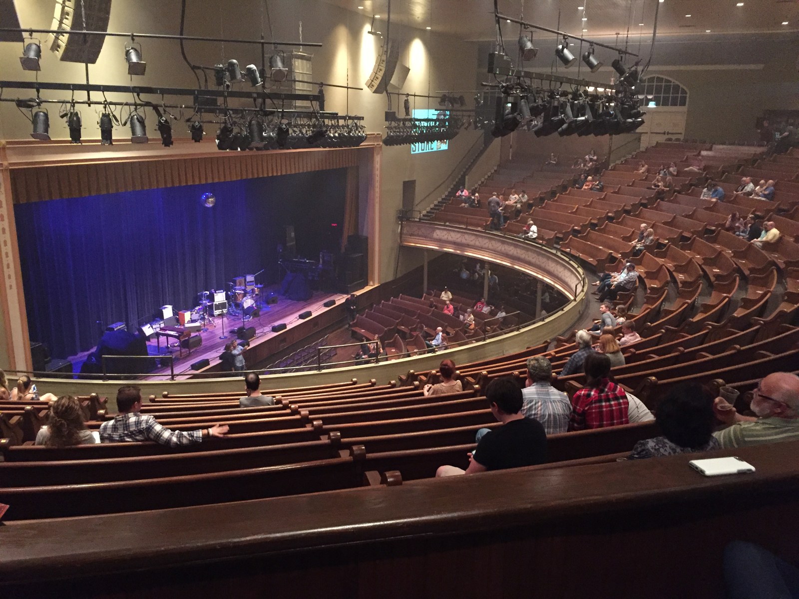 Ryman Auditorium’s stage, balcony, and wooden pew seating before a show.