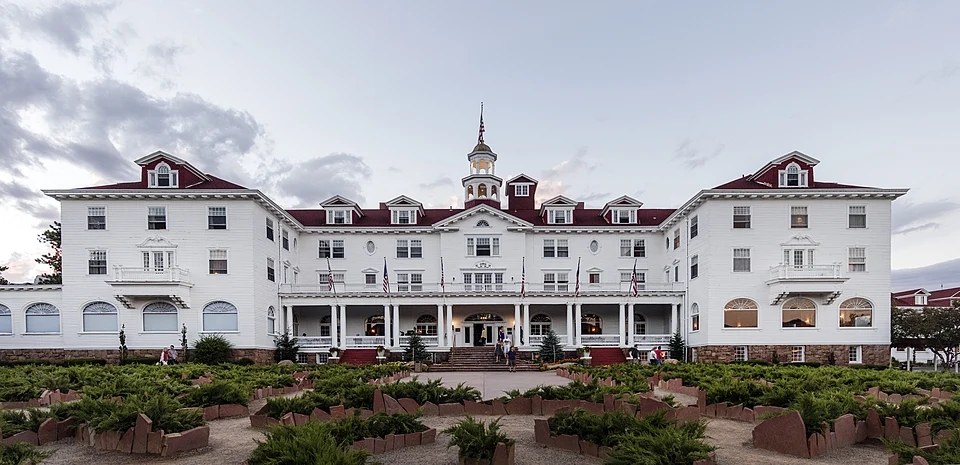 The white facade and red roof of the Stanley Hotel in Estes Park, Colorado.