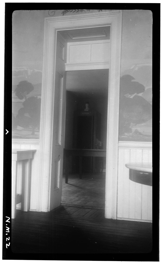 An archival photograph of a tall interior doorway and transom at the St. James Hotel.