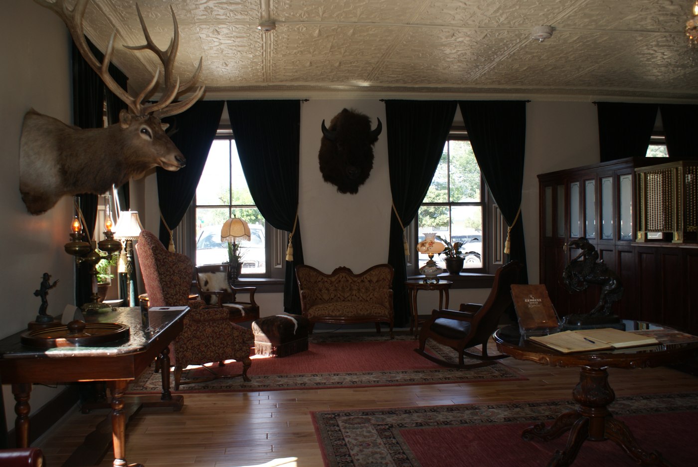 The St. James Hotel parlor in 2009, showing wood floors, antique furnishings and mounted wildlife.